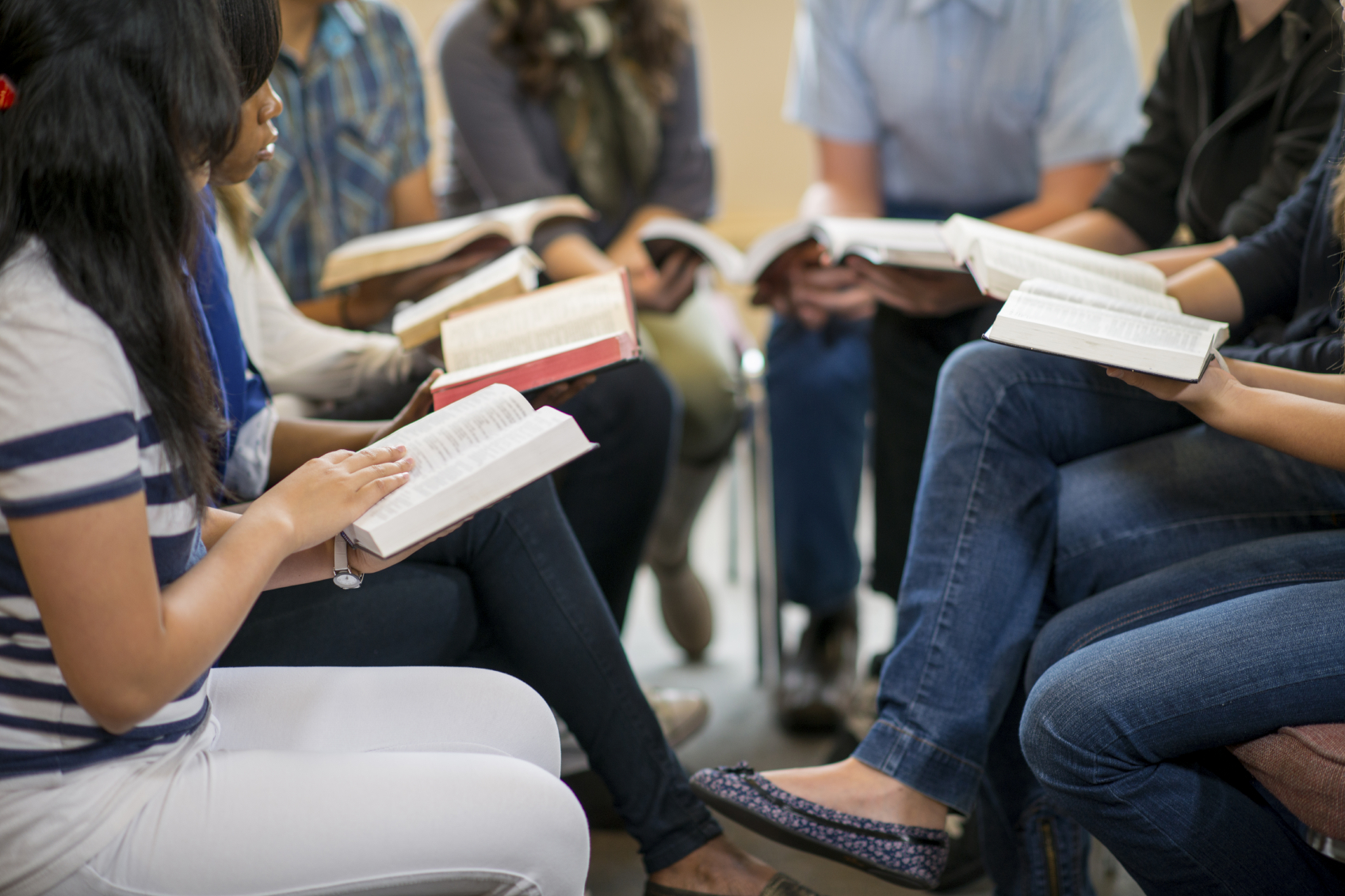 people gathering with bibles