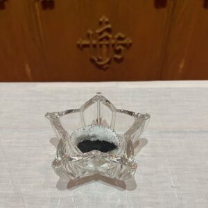 glass star shaped bowl with ashes on fair linen